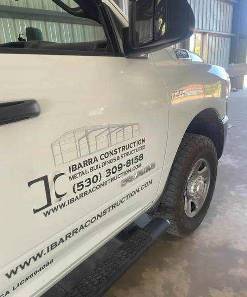 Ibarra Construction truck showcasing branding, contact information, and metal building services.