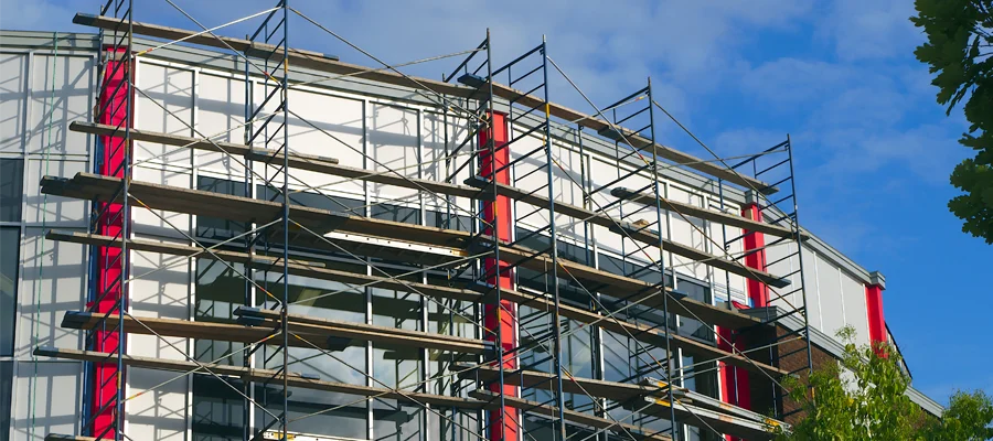 Scaffolding structure on a building under renovation, showcasing metal framework and planks, reflecting Ibarra Construction's expertise in structural improvements and remodeling services in Woodland, CA.