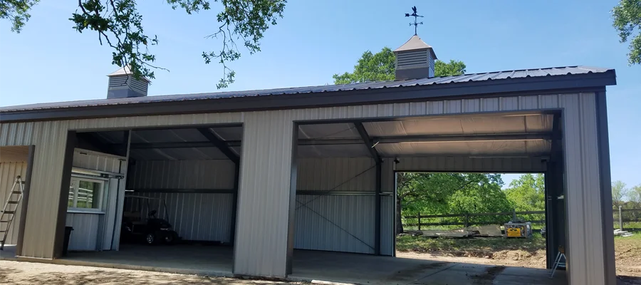 Metal building structure with open bays, featuring a gabled roof, cupola, and durable steel framework, showcasing Ibarra Construction's expertise in custom metal buildings for agricultural and commercial use in Fairfield, CA.