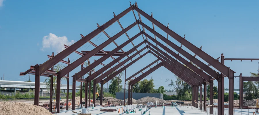 Steel frame structure under construction, showcasing metal building installation for Ibarra Construction's services.