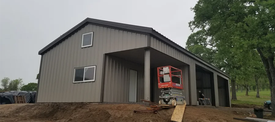 Metal building under construction in Vacaville, CA, featuring a steel frame, large windows, and a covered entryway, exemplifying Ibarra Construction's expertise in durable and versatile structures.