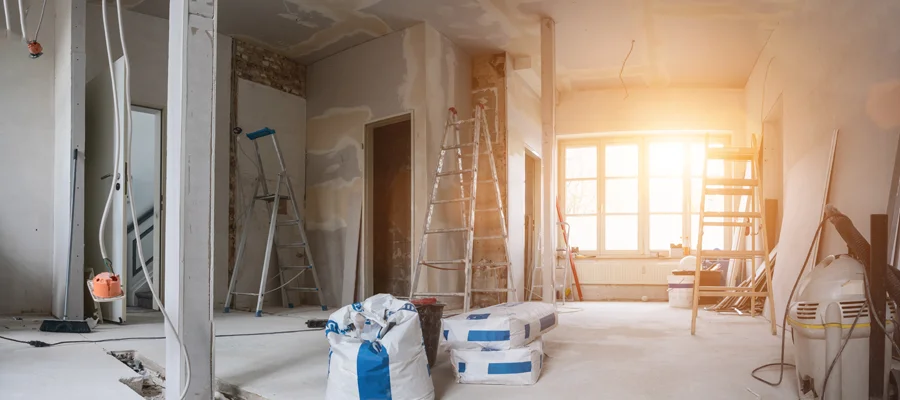 Interior renovation workspace with construction materials, ladders, and equipment, illustrating Ibarra Construction's remodeling services for enhancing metal and steel structures.