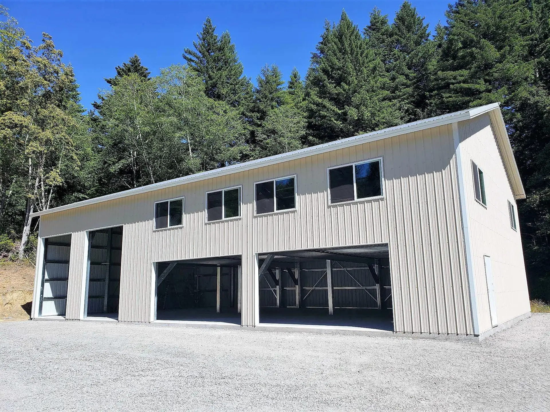 Red iron steel building in Northern California with large garage doors and durable metal siding.