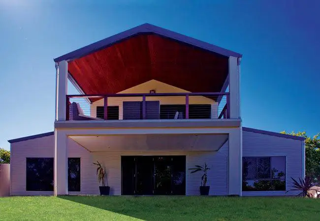 Modern two-story house with steel framing and balcony, showcasing cold-formed steel building design.