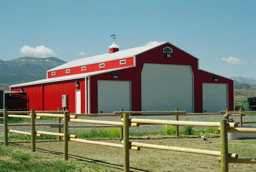 Red iron steel building and horse arena design for Northern California equestrian space.