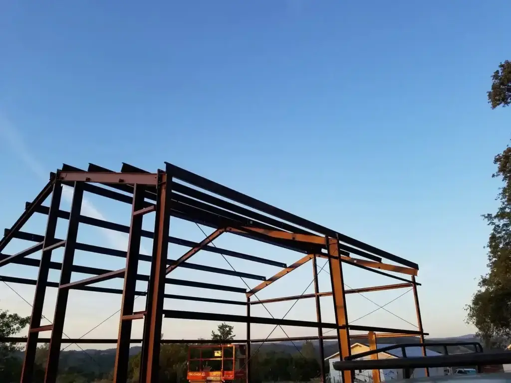 Steel arena construction in progress, prefabricated steel erection and framing for equestrian facility.